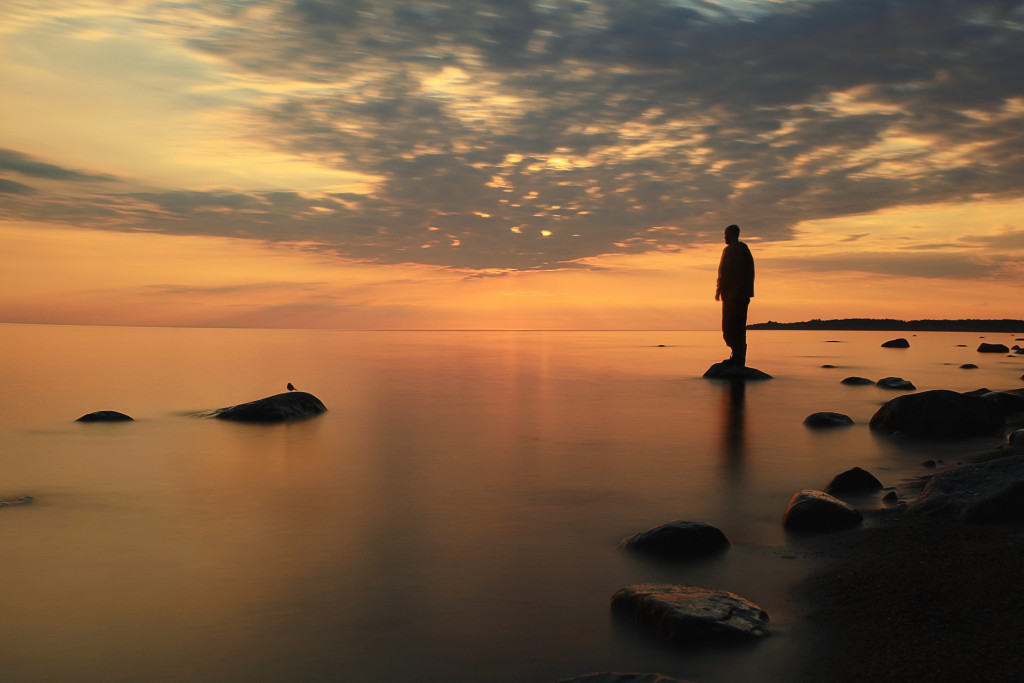 man meditates on the lake